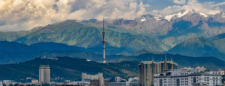 A traditional wooden boat carrying passengers on calm blue waters under a clear sky in Musandam 