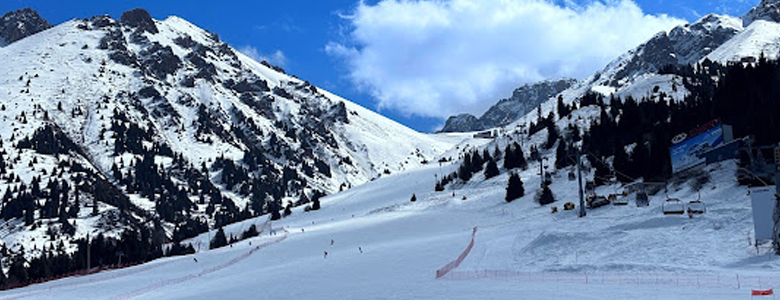 A traditional wooden boat carrying passengers on calm blue waters under a clear sky in Musandam 
