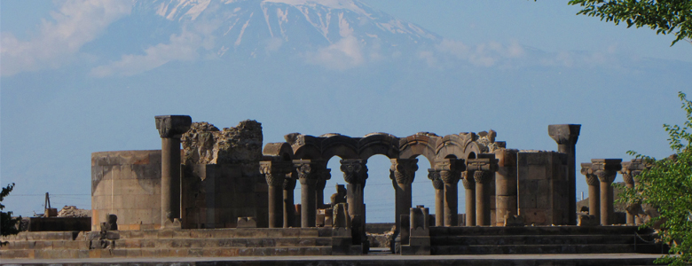 A traditional wooden boat carrying passengers on calm blue waters under a clear sky in Musandam 