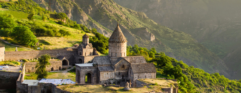 A traditional wooden boat carrying passengers on calm blue waters under a clear sky in Musandam 