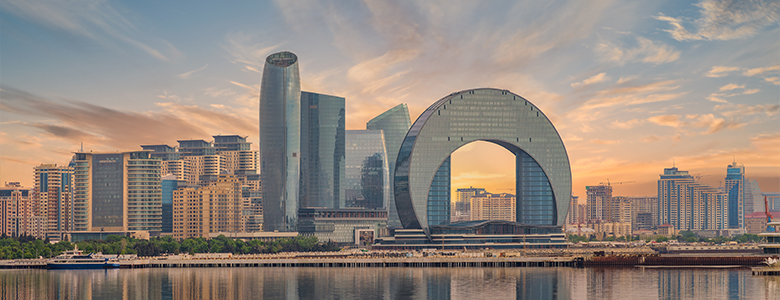A traditional wooden boat carrying passengers on calm blue waters under a clear sky in Musandam 