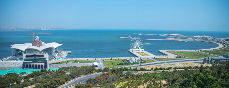 A traditional wooden boat carrying passengers on calm blue waters under a clear sky in Musandam 