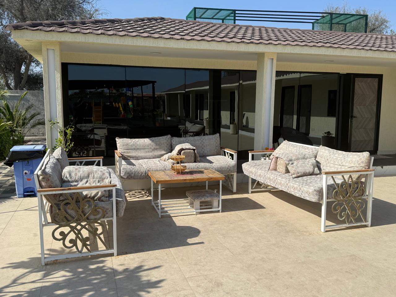 A traditional wooden boat carrying passengers on calm blue waters under a clear sky in Musandam 