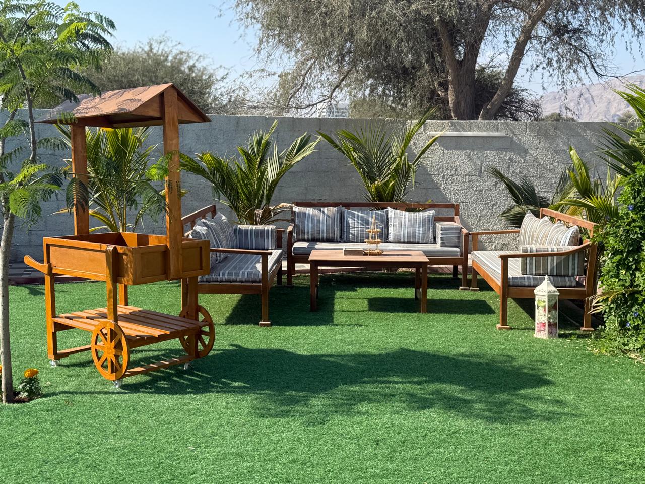 A traditional wooden boat carrying passengers on calm blue waters under a clear sky in Musandam 