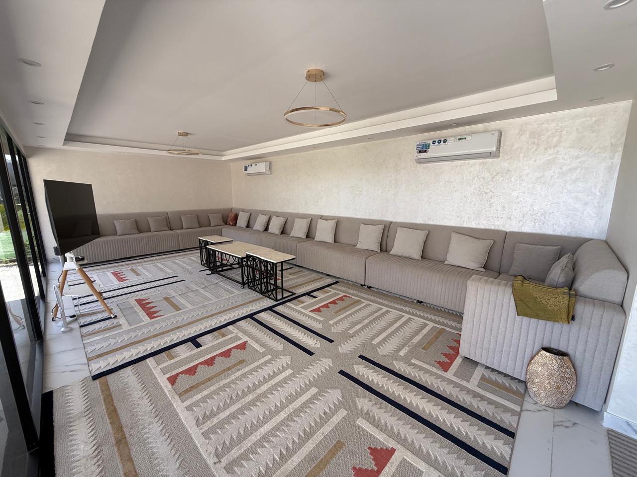 A traditional wooden boat carrying passengers on calm blue waters under a clear sky in Musandam 