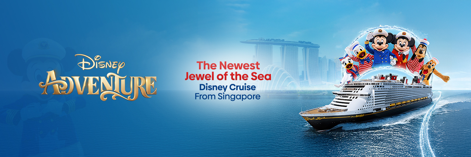 A traditional wooden boat carrying passengers on calm blue waters under a clear sky in Musandam 