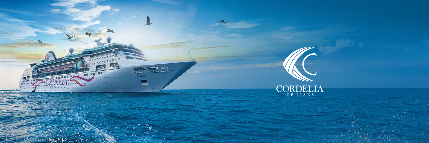A traditional wooden boat carrying passengers on calm blue waters under a clear sky in Musandam 